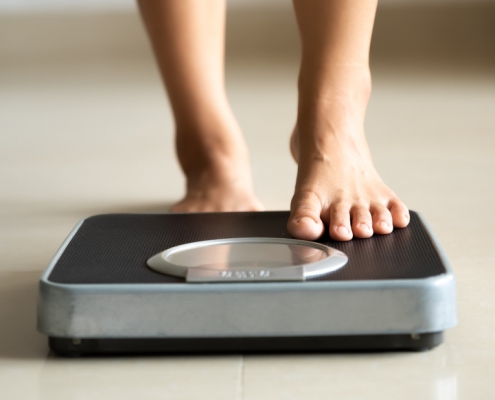 person stepping on a scale