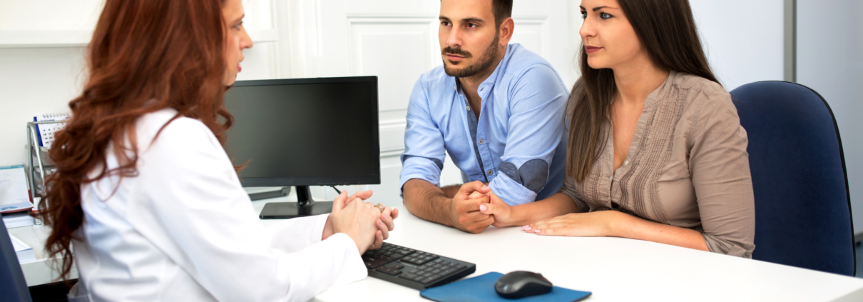 Husband and wife in a clinic, young couple at fertility (IVF) consultation