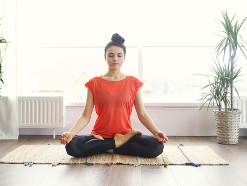 woman meditating on the floor