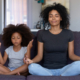 mother and daughter meditating together