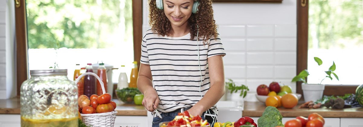 Woman cooking and listening to music