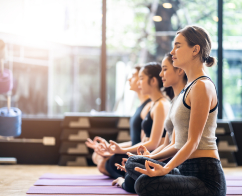 women in a yoga studio meditating