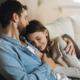 man and woman together on a couch