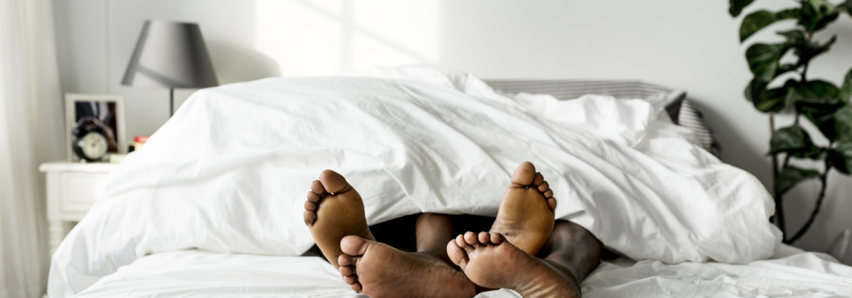 Black couple lying on bed together sex concept