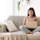 woman sitting on the couch with a laptop