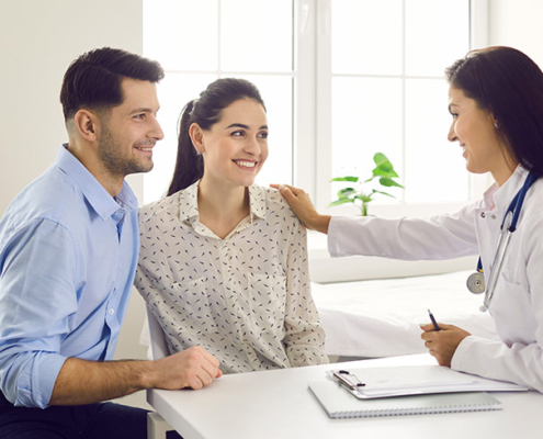 A female doctor consulting a couple for IVF treatment.