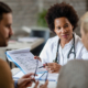 Female doctor talking to a couple in an office about the egg retrieval process.